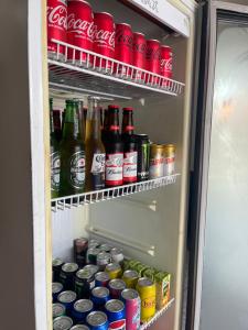 an open refrigerator filled with lots of soda cans at Hostel Wei in Boa Vista