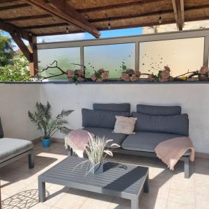 a patio with a couch and a table at Chez Jack Confolens in Confolens