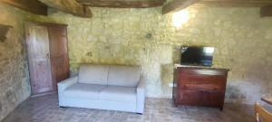 a living room with a white couch and a tv at Guesthouse Nicol 2 in Collelungo