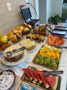 a table topped with lots of different types of food at POUSADA ESTÂNCIA in Penedo