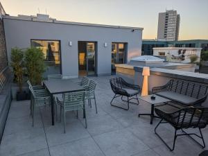 a patio with tables and chairs and a grill at NG19. YOUR INSPIRING HOMEBASE. in Berlin