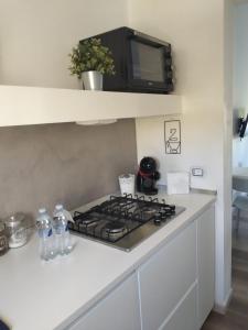 a kitchen with a stove and a counter top at CasaMarè in Taranto
