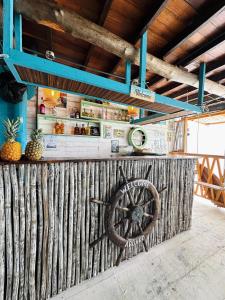 a restaurant with a wooden fence with a wheel on it at Itaca Eco House in Playa Blanca