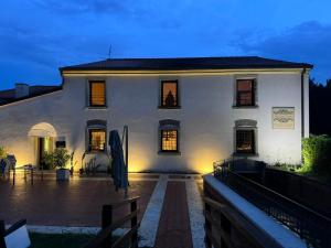 a white house with a courtyard at night at Hacienda De Leon in Isola della Scala