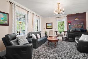 a living room with a couch and chairs and a table at Shopping Restaurants 6 mins to Beach AC in Yarmouth