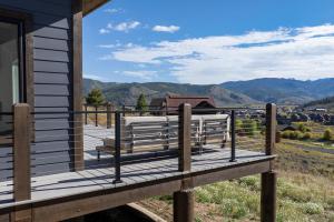 a porch of a house with a view of the mountains at Scenic Perch home in Tabernash