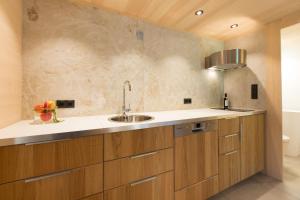 a kitchen with wooden cabinets and a sink at Ferienloft Waldblick in Schwarzenberg