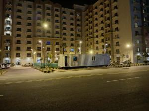 an empty street in front of a large building at night at 1 Bedroom 1BHK Elegant Secure & Luxury Apartment in islamabad in Islamabad