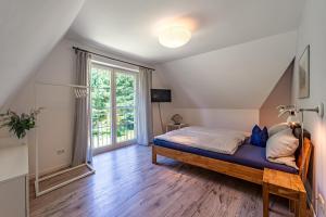 a bedroom with a bed and a large window at Haus 172, Lärchenweg 1 in Ostseebad Karlshagen