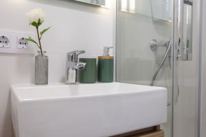 a bathroom with a sink and a glass shower at Estudio Bianca in L'Escala