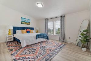 a bedroom with a bed with a rug and a window at Watkins Glen Hot Tube Retreat- Finger Lakes Region in Burdett