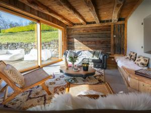 a living room filled with furniture and a large window at La Ferme des Artistes - OVO Network in Mieussy +26 photos