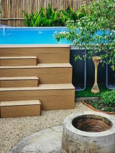 a swimming pool and stairs in a garden at Le lanna villa at Center of old town with private pool in Chiang Mai