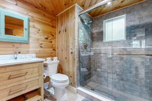 a bathroom with a shower and a toilet and a sink at Drummer Cove Retreat in Wellfleet +18 photos