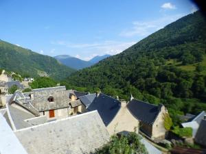an aerial view of a building with mountains in the background at Maison familiale pour 8 in Saint-Aventin