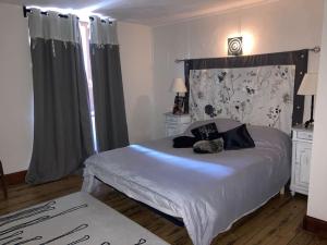 a bedroom with a large white bed in a room at Maison familiale pour 8 in Saint-Aventin