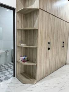 a wooden book shelf in a room with a toilet at Memory House in Phúc Yên