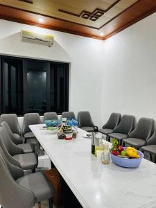 a conference room with a long table and chairs at Memory House in Phúc Yên