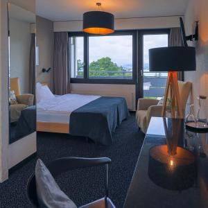 a hotel room with a bed and a window at Guggital Hotel Restaurant in Zug +246 photos