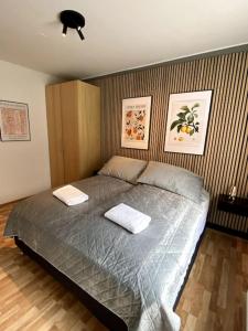 a bedroom with a bed with two pillows on it at 4-room spacious condo w patio in Reykjavík