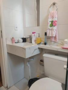 a bathroom with a toilet and a sink and a mirror at Apartamento - Marilândia Juiz de Fora in Juiz de Fora +8 photos