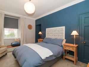 a blue bedroom with a bed and a blue wall at Humphreston House in Bristol