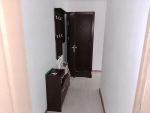 a hallway with two black stalls in a bathroom at Apartment near the Sea in Ventspils