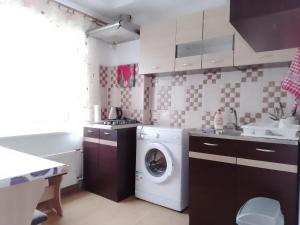 a kitchen with a washer and a washing machine at Apartment near the Sea in Ventspils
