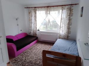 a small room with a couch and a window at Apartment near the Sea in Ventspils