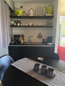 a kitchen with a table with cups on it at Agriturismo Affaccio su Orvieto in Orvieto +49 photos