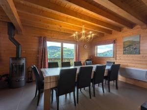 a dining room with a long table and chairs at Le Grand Chalet Bellevue - parking Wifi BBQ in La Bresse
