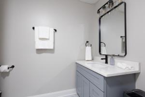 a white bathroom with a sink and a mirror at Two Cabins, Walk to Helen, Air Hockey, Theater in Helen +35 photos