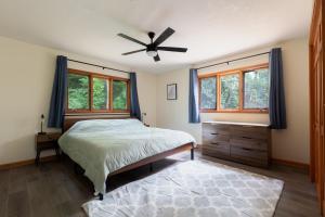 a bedroom with a bed and a ceiling fan at Two Cabins, Walk to Helen, Air Hockey, Theater in Helen
