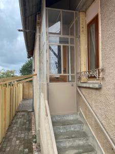 a building with stairs leading up to a window at Chaleureuse in Saint-Julien-les-Villas