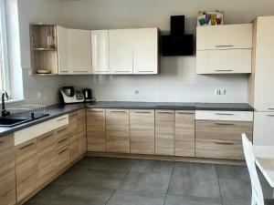 a kitchen with white cabinets and a sink at Dworek Sadlinki in Sadlinki