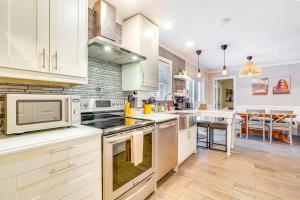 a kitchen with white appliances and a dining room at Mtn Views and Fire Pit Eureka Springs Home in Eureka Springs