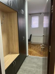 a bathroom with black cabinets and a wooden floor at Altina Gottfried Studio in Novi Grad +1 photo