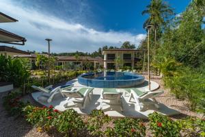 a patio with chairs and a swimming pool at SHI Phangan Villas in Hinkong