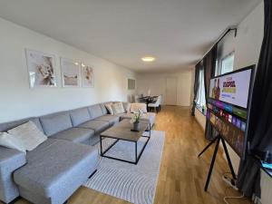 a living room with a couch and a flat screen tv at Modern and complete House in Västerås