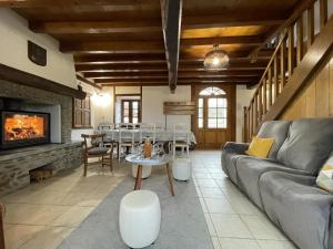 a living room with a couch and a fireplace at Loustaou in Osserain-Rivareyte