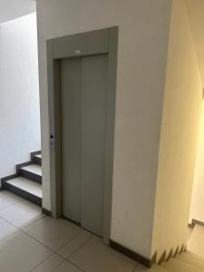 an elevator door in a building with stairs at Altina Gottfried Studio in Novi Grad