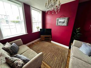 a living room with a couch and a tv at Entire home in perfect old town location in Hull