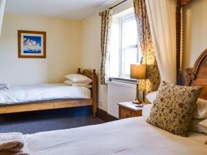 a bedroom with two beds and a window at Eastfield Cottage Free Parking And Ev Charger in Leven