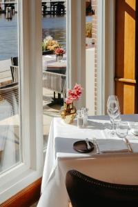 a table with a white table cloth on a table with a window at InterContinental Amstel Amsterdam by IHG in Amsterdam +37 photos