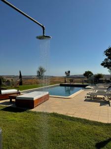 a swimming pool with a fountain in a park at Agriturismo Re Tarquinio in Tuscania +116 photos