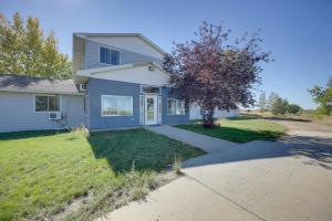 a blue house with a tree in the yard at Malta Vacation Rental about 2 Mi to Town! in Malta