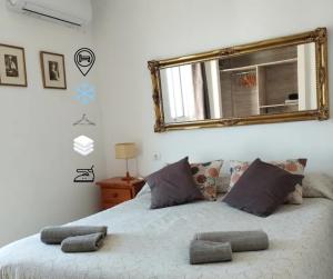 a bedroom with a bed with a mirror on the wall at Grandpa Beach House in Alicante +34 photos