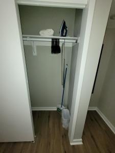 an empty room with a shelf and a broom at Aksarben Gem-Easy access to I-80 in Omaha