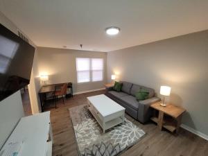 a living room with a couch and a table at Aksarben Gem-Easy access to I-80 in Omaha