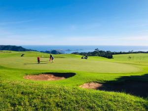 a group of people playing on a golf course at Casa do sol in Santa Cruz